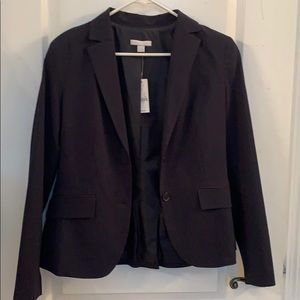 Black pinstripe suit jacket tags still attached